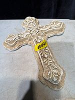 Front view of ornate plaster wall cross showing full design and texture