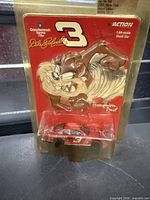 Front of sealed blister card showing car, graphics, scale and brand details