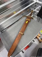 Sword in scabbard full length view