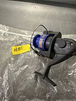 Side view of Zebco 223 spinning reel showing blue spool, bail arm, handle and model number