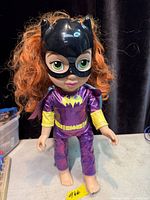 Front view of Batgirl toddler doll showing costume, mask and hair
