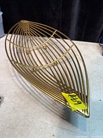 Angled top view of gold-tone metal wire basket tray