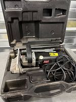 Freud biscuit joiner inside its molded carrying case, cord coiled