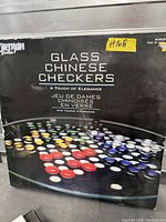 Front of boxed Artisan Games Glass Chinese Checkers