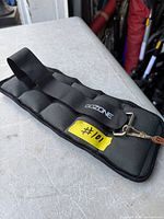 Front view of GOZONE adjustable weight cuff showing strap, segments, and metal D-ring