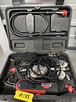Open case showing Jobmate rotary tool, flex shaft, accessories and packaging