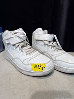 Side view of both sneakers showing upper, laces and ankle strap