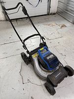 Full view of Mastercraft cordless lawn mower showing handle and body