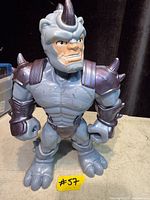 Front view of Rhino action figure showing grey body, purple armor, horn and articulated joints