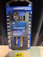 Front view of sealed Mastercraft 21-piece mechanics tool set showing ratchet, extensions, and sockets