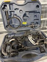 Open Mastercraft case showing rotary tool, flexible shaft, router base, cutting guide, collets and cord