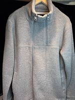 Full view of grey Bench zip-up jacket on hanger