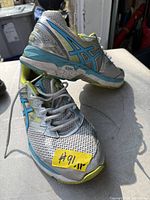 Top and side view of Asics men's sneakers showing colorway size label and overall condition