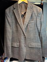 Front view of brown-grey plaid two-button blazer on hanger