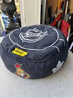 Top view showing NHL shield logo on puck-shaped cushion