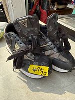 Front and side view of both sneakers showing overall style, size tag, and condition