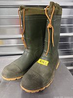 Front and side view of both Kamik boots showing color, laces, and exterior condition