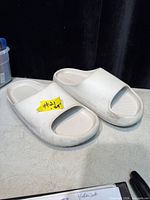 Top view of off-white slide sandals pair