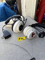 Both headphones side by side showing overall appearance and included charger