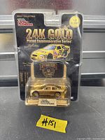 Front view of sealed Racing Champions 24K Gold Plated die-cast car in original packaging