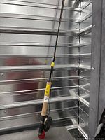 Full view of fly rod and reel leaning against wall