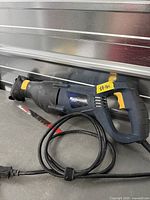 Mastercraft corded reciprocating saw with attached blade and power cord displayed on work surface