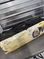 Tent packed in black zip carrying bag with product sleeve