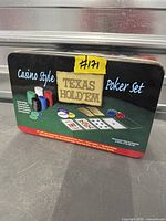 Closed black tin showing Texas Hold'em Casino Style Poker Set graphics