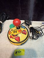 Overall view of Pac-Man plug-and-play joystick showing controls and attached AV cable