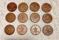 Front view of 12 UK 2-pence coins showing reverse side with Prince of Wales feathers