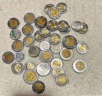 Overview of all 36 Mexican coins spread on fabric
