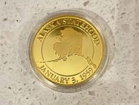 Obverse showing Alaska outline and statehood date