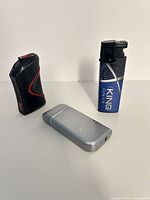 All three lighters standing upright for scale and style comparison