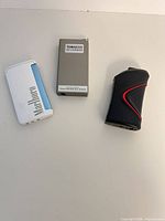 Three lighters grouped: white Marlboro, grey Toracco, black torch