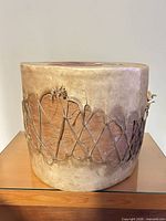 Side view showing rawhide body and laced pattern