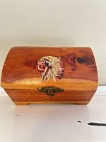 Front view showing wooden box, decal and latch
