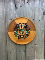 Front view of cedar plaque showing full painted design