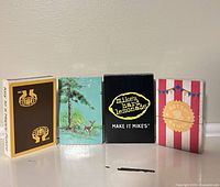 Fronts of all four sealed playing card decks aligned side by side