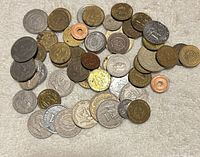 Overview of mixed Philippine coins spread out, showing variety of denominations and metals