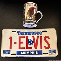 License plate and mug together on dark surface