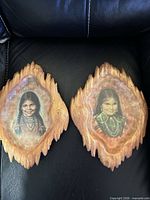 Both wall plaques side by side on black background