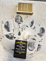 Spread of playing cards with Yukon scenery, box and story card visible