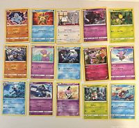 Full spread of all 15 Pokémon cards laid out in three rows