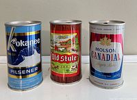 Front view of all three vintage beer cans
