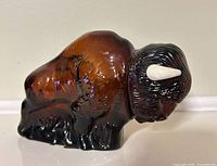 Right side view of brown glass buffalo decanter with stopper inserted