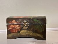 Front view showing floral painting and latch