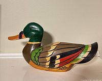 Left profile of painted wooden duck decoy