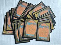 Stack of card backs showing standard MTG Deckmaster design