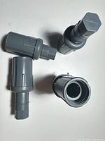 four gray plastic adjustable bullet feet displayed