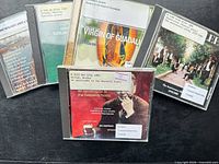 Front view of all five CDs showing cover art and library labels